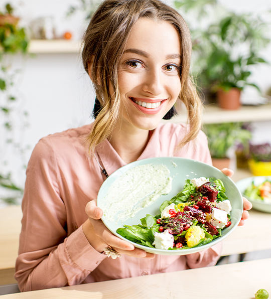woman using MD Weight Solutions works on nutrition by eating a healthy salad